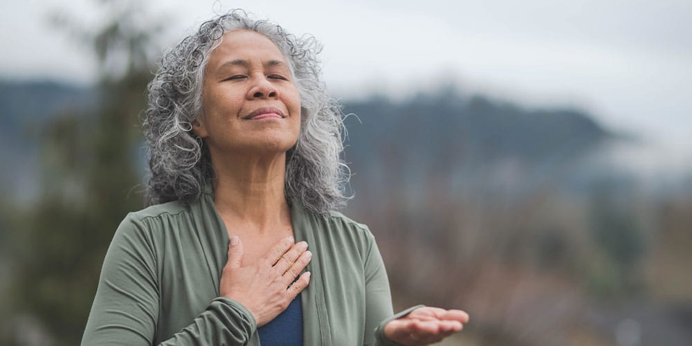 older woman outside recovering after breast implant removal surgery in Bloomfield Township, IL