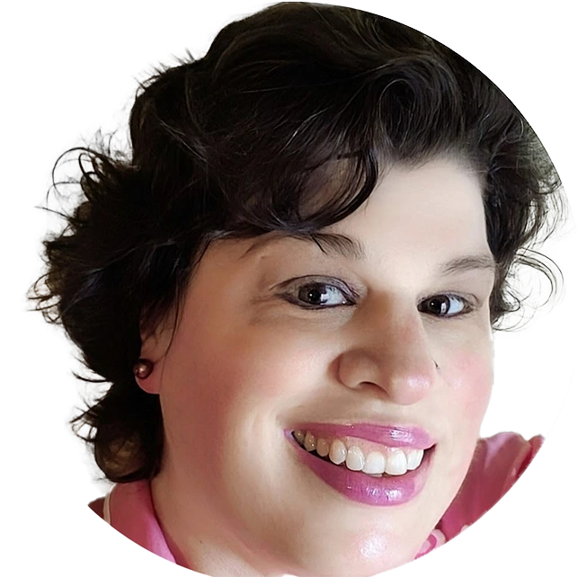 Woman with dark wavy hair and pink lipstick smiling at camera