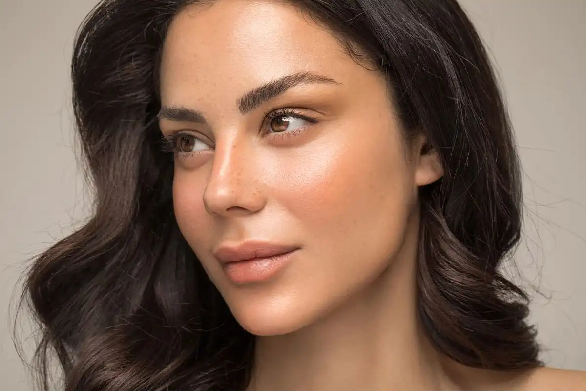 Woman with smooth, glowing skin and defined facial features