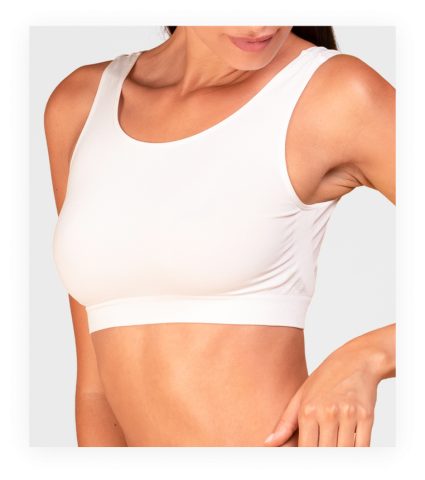 Woman wearing white sports bra showing torso and midriff