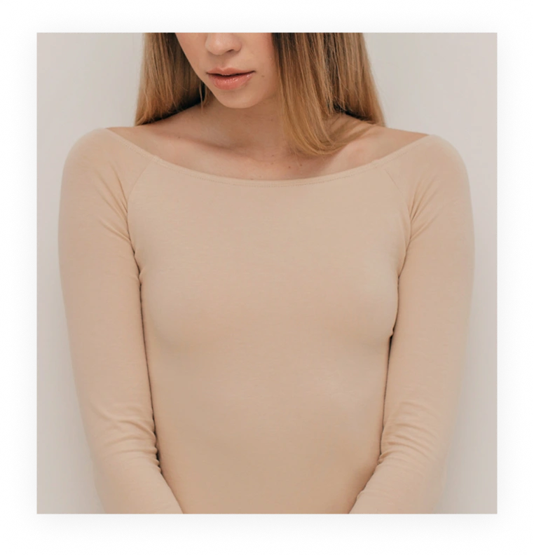 Woman's upper body and shoulders demonstrating natural chest contour