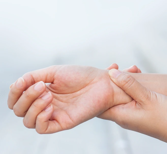 One hand resting on another hand in gentle, caring gesture