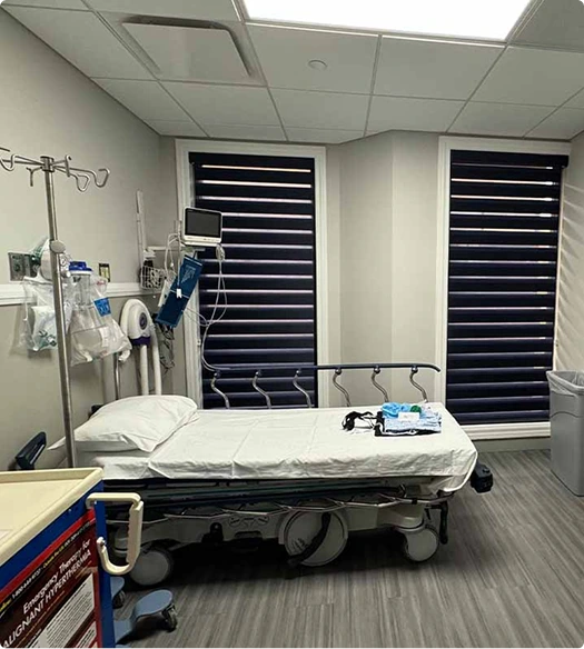 Surgical recovery bed with IV stand and medical equipment in operating room