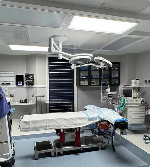 Surgical suite with overhead lighting, surgical bed, and medical monitoring equipment
