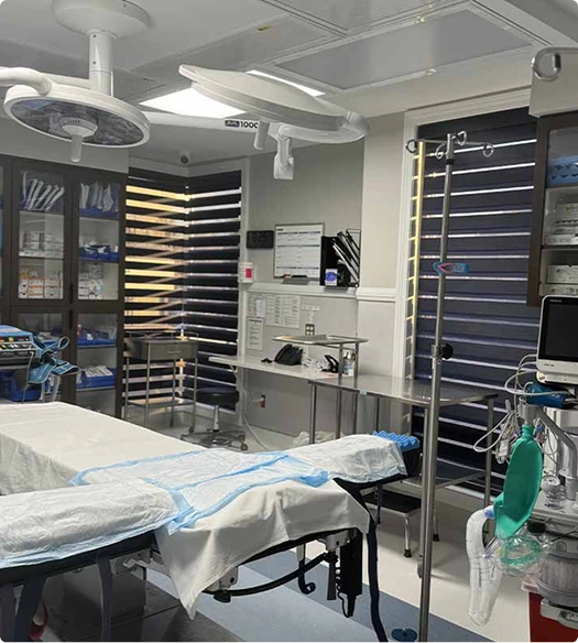 Operating room with surgical lights, bed, instrument cabinets, and monitoring equipment