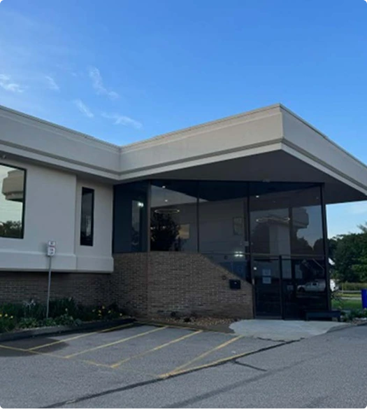 Contemporary surgical practice building entrance with brick and dark glass facade